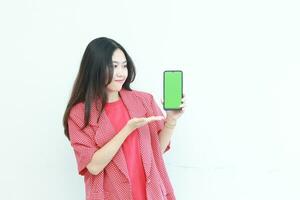 portrait of beautiful asian woman wearing red outfit holding mobile phone and smiling photo