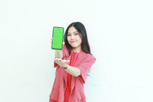 portrait of beautiful asian woman wearing red outfit holding mobile phone and smiling photo