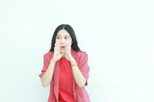 portrait of beautiful asian woman wearing red outfit with whispering gesture photo