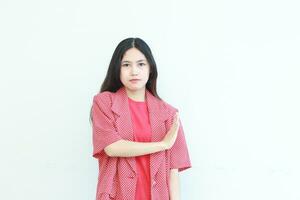 portrait of beautiful asian woman wearing red outfit with rejection or disapproval gesture photo