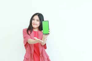 portrait of beautiful asian woman wearing red outfit holding mobile phone and smiling photo