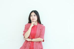 portrait of beautiful asian woman wearing red outfit with thinking gesture photo