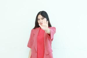 portrait of beautiful asian woman wearing red outfit with rejection or disapproval gesture photo