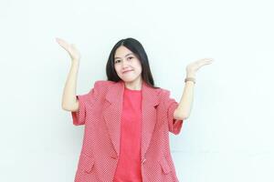 portrait of beautiful asian woman wearing red outfit pointing up for copy space with smiling gesture photo