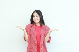 portrait of beautiful asian woman wearing red outfit with hand gesture presenting something or copy space photo