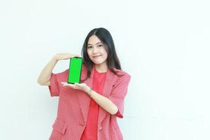 portrait of beautiful asian woman wearing red outfit holding mobile phone and smiling photo