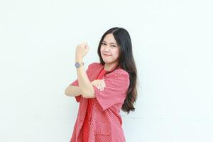 portrait of beautiful asian woman wearing red outfit with strong hand gesture photo