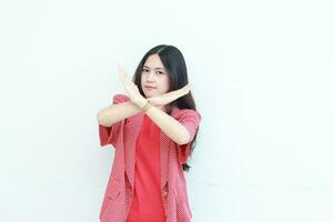 portrait of beautiful asian woman wearing red outfit with rejection or disapproval gesture photo