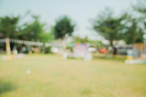 Defocused bokeh and blur background of garden trees in sunlight with vintage toned. photo