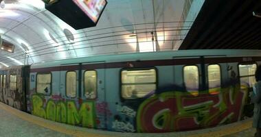 Undeground train with graffiti leaving station video