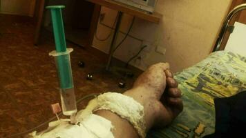 Hand of sick person with syringe and drip video