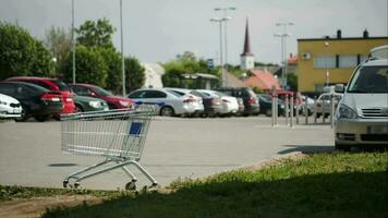 Timelapse of traffic on parking zone with empty shopping cart video