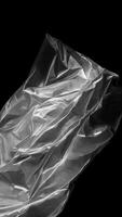 Wrinkled plastic wrap texture on a black background. AI generated photo