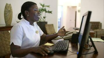 Woman receptionist at spa talking to guest video