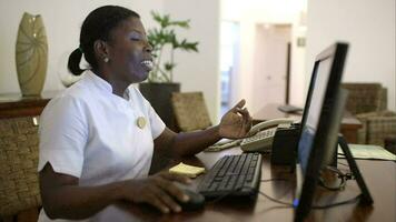 Woman receptionist at spa talking to guest video