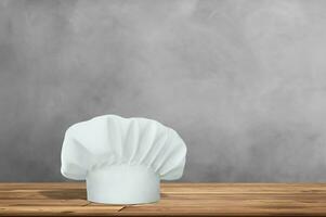 Wooden table with empty space and cook hat photo