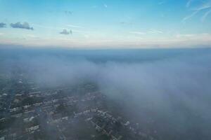 Most Beautiful and Best High Angle Dramatical Colourful Sky Footage from Above The Clouds. The Fast Moving Clouds During Sun rising Early in the Morning over Luton City of England UK photo