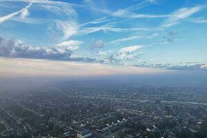 Most Beautiful and Best High Angle Dramatical Colourful Sky Footage from Above The Clouds. The Fast Moving Clouds During Sun rising Early in the Morning over Luton City of England UK photo