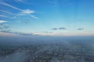 Most Beautiful and Best High Angle Dramatical Colourful Sky Footage from Above The Clouds. The Fast Moving Clouds During Sun rising Early in the Morning over Luton City of England UK photo