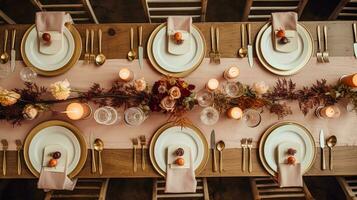 Autumn holiday tablescape, formal dinner table setting, table scape with elegant autumnal floral decor for wedding party and event decoration photo