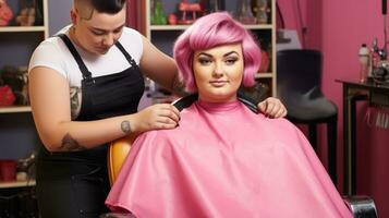 Woman plus size with pink hair in a beauty salon . The master does haircut photo