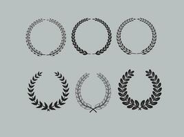 Laurel wreath. Set of outline and silhouette vector hand drawn laurel wreaths isolated on grey background. Doodle style. Outline and silhouette floral frames.