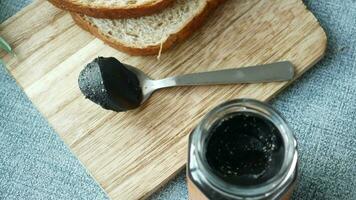 Black sesame spread on a bread , video