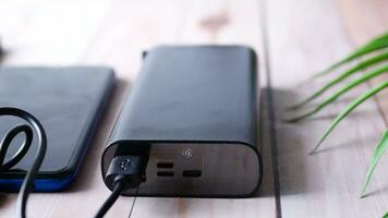 smart phone charging with Power bank top view. video