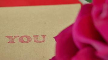 envelope, paper and tulip flower on table , video