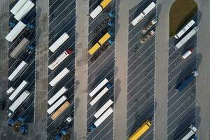 Top view of trucks on parking lot near logistic warehouse photo