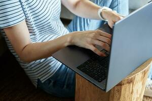 Woman hands typing on laptop keyboard photo