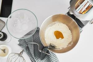 Top view of bowl with flour and ingredients on table photo