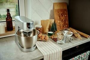 Electric mixer kneads dough in the kitchen photo