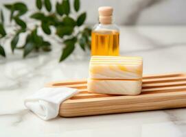 A spa with bar soap and a bottle of oil photo