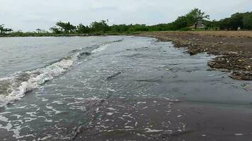 Akkarena beach video in Indonesia, with small waves hitting the shoreline