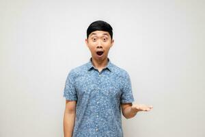 Positive asian man feels amazed show empty hand up isolated photo