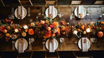 Autumn holiday tablescape, formal dinner table setting, table scape with elegant autumnal floral decor for wedding party and event decoration photo