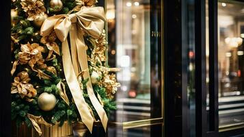 Christmas decoration details on English styled luxury high street city store door or shopping window display, holiday sale and shop decor photo