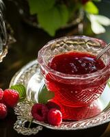 Raspberry jam and raspberries in a crystal bowl, country food and English recipe idea for menu, food blog and cookbook photo