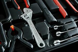 Set of tools for repair and maintenance on black background photo