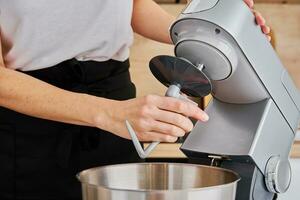 Woman cooking at preparing food, using food processor, photo