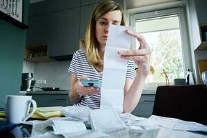 Woman calculating payment bill at home photo