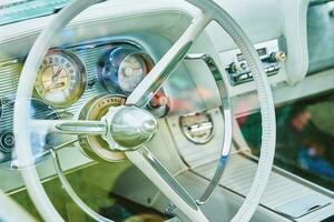 Retro car dashboard with srteering wheel photo