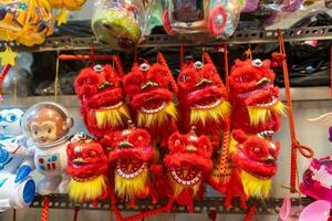 Decorated colorful lanterns hanging on a stand in the streets in Ho Chi Minh City, Vietnam during Mid Autumn Festival. Chinese language in photos mean money and happiness. Selective focus.