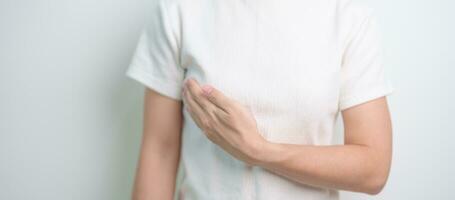 Woman having Breast pain and Check Body Chest. Pink October Breast Cancer Awareness month, National cancer survivors month, Mother, World cancer day and Health diagnosis concept photo