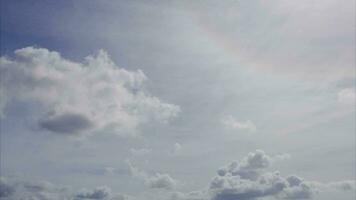 Low Angle view Time lapse of direct bright noon sun on blue sky with clouds with sun shining on summer day video