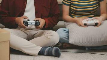 Moving to a new apartment. Happy newlyweds bought their first home, stand in the living room among the boxes, hold cardboard boxes in their hands, prepare to unpack things, look at the camera, smile video