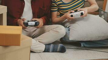 Moving to a new apartment. Happy newlyweds bought their first home, stand in the living room among the boxes, hold cardboard boxes in their hands, prepare to unpack things, look at the camera, smile video