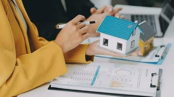 Female woman hands holding home model, small miniature white toy house. Mortgage property insurance dream moving home and real estate concept video