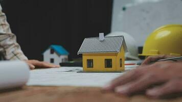Construction and structure concept of Engineer or architect meeting for project working with partner and engineering tools on model building and blueprint in working site, contract for both companies. video